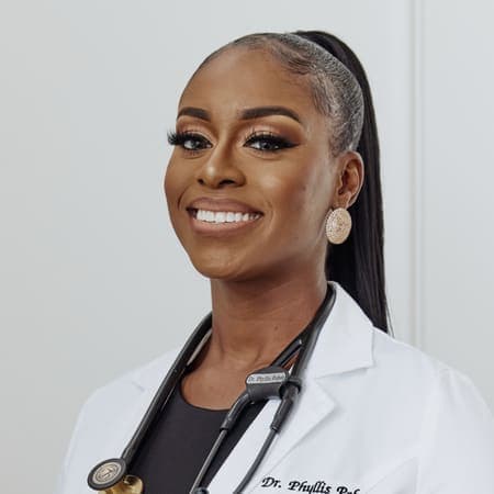 Dr. Phyllis Pobee, MD, in her white coat